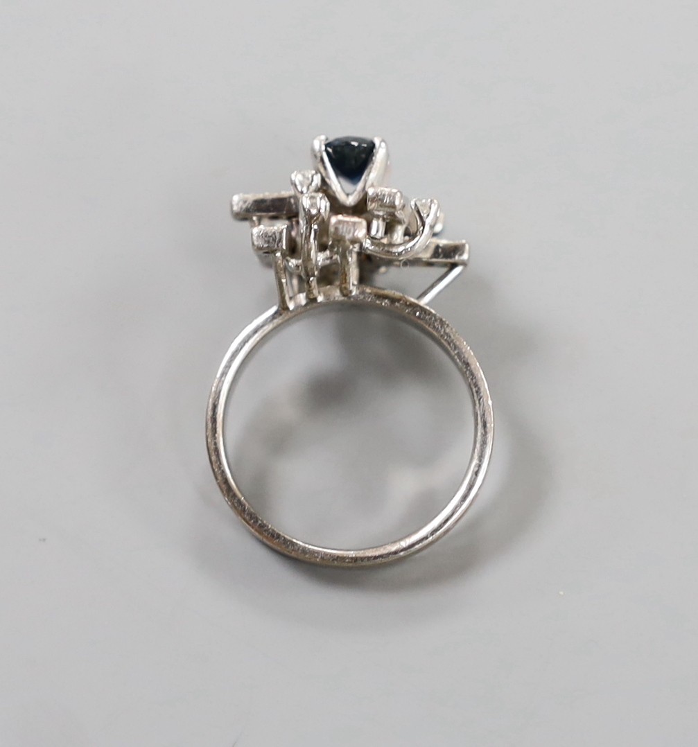 A modern 18k, sapphire and diamond cluster set dress ring, size K, gross weight 6 grams.